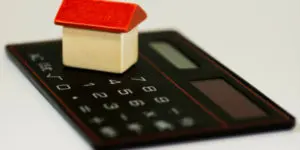 A calculator and some house on top of it