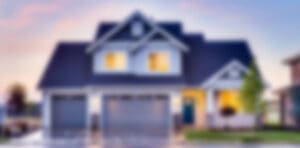 A blurry picture of a house with lights on.