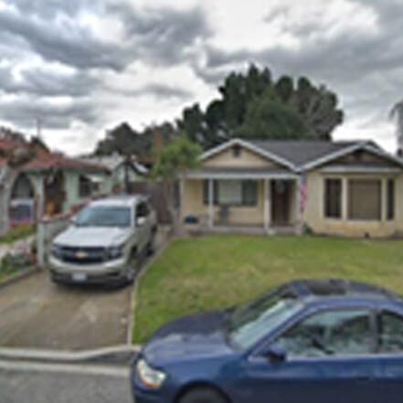 Silver SUV parked in the driveway of house