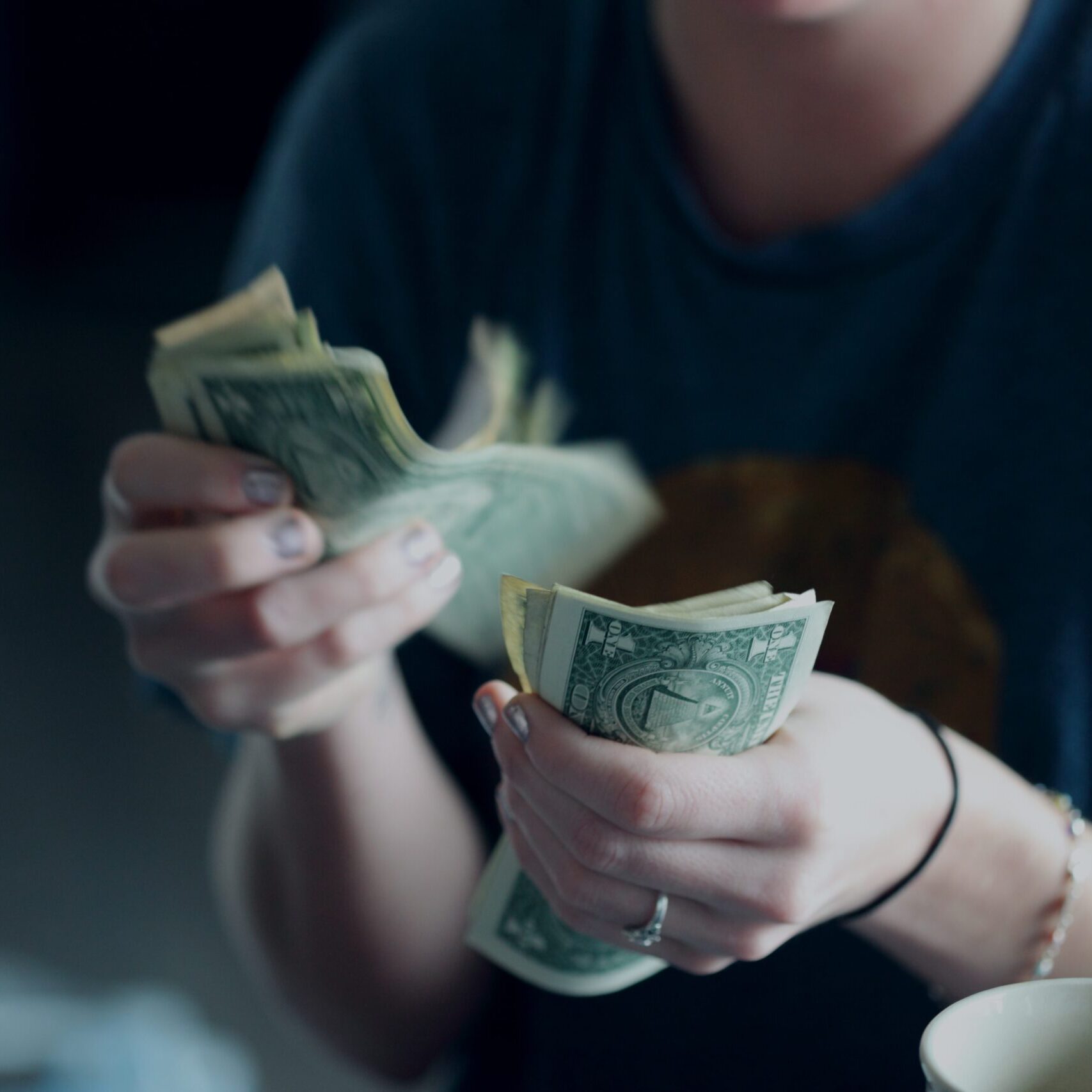 A person holding money in their hands.