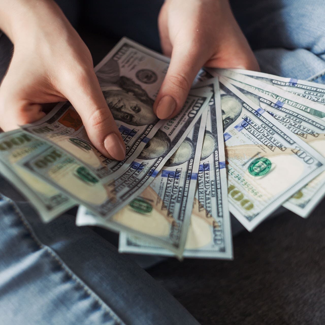 A person holding money in their hands