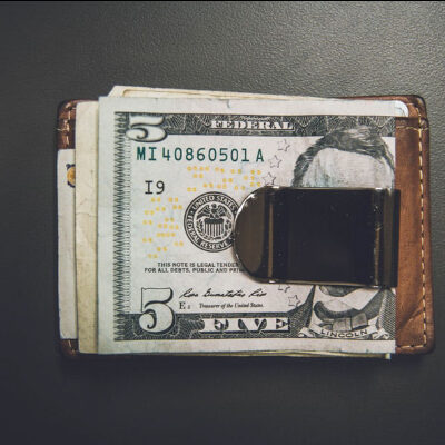 A close up of a wallet with money sticking out